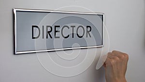 Director office door, manager hand knocking closeup, business company leader