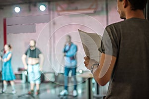 Director rehearses the play with actors according to the script