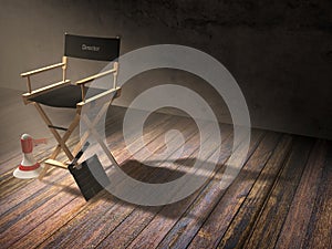 Director`s chair with clapper board and megaphone in dark room scene with spotlight light