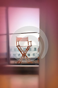 Director\'s chair on colorful background with equipment for recording