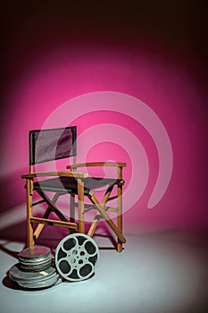 Film director's chair with movie reel photo
