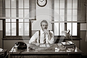 Director working at office desk