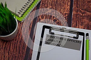 Directors & Officers Liability Insurance write on paperwork isolated on wooden table