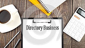 DIRECTORY BUSINESS text on paper with coffee, calculator and notebook. Business concept
