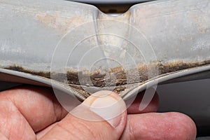 Dirt and fungus from moisture on the sealing gum of the washing machine drum. Washing machine cleanliness and care concept