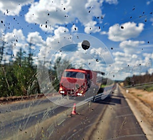 Dirt highway with dirt flies on the windshield