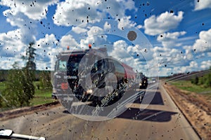 Dirt highway with dirt flies on the windshield