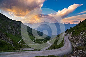 Dirt mountain road leading to high mountain pass