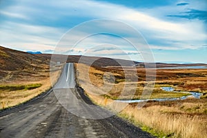 A dirt road against a hill with vanishing point, Husavik, Iceland