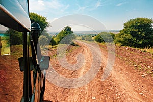 Dirt road against the Savannah Grassland landscapes of Nairobi National Park, Kenya