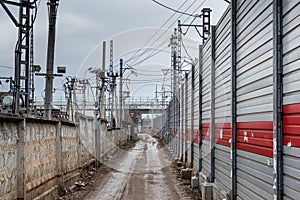 Dirt road along the fence. A grim industrial landscape