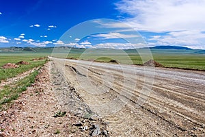 Dirt road & blue sky, Mongolian steppe