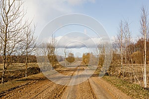 A dirt road in the countryside goes into the distance.