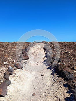 Dirt road in desert landscape under blue sky. Deserts and extreme nature. Outdoor sports