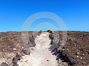 Dirt road in desert landscape under blue sky. Deserts and extreme nature. Outdoor sports