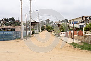 Dirt road on empty street by Algarrobo beach photo