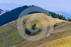 Dirt road high in the mountains that goes down to the village in the valley