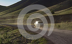 Dirt road in Kyrgyzstan mountains with car