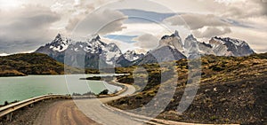 Dirt road leading around the lake to stunning Cuernos del Paine in Patagonia. Torres del Paine National Park, Patagonia, Chile the