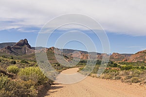 Dirt road leading over mountain pass in daytime