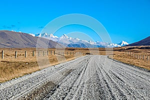Dirt road leading to mountains in Ashburton Lakes District, South Island, New Zealand