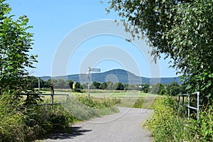 dirt road across a bridge with a view to a volcano hill in the Eifel photo