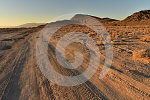 Dirt road in Mojave desert dawn landscape