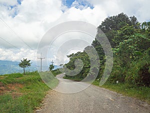 Dirt road in the mountain of Northern Thailand with nature background