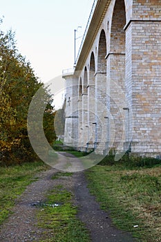 Dirt road next to rail bridge