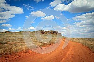 Dirt road orange prairie, going to the sky