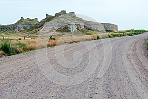 A dirt road passes buttes in southwestern Nebraska