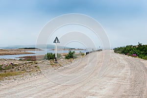 Dirt road in a polar landscape with granite stones