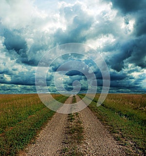 Dirt Road Through the Prairie in Storm