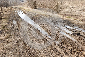 Dirt road with puddles after rain.