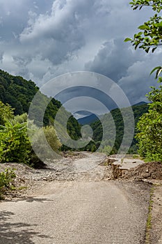 Road in the stonebed of mountain river