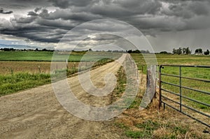 Dirt road to a stormy sky