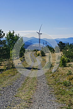 Dirt road to wind turbines in the grasslands of the Croatian mountains.