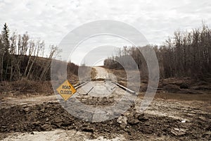 Dirt road under repair with warning sign