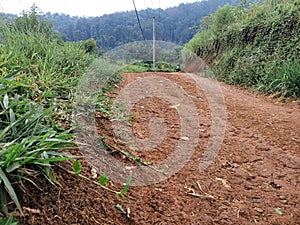 a dirt road in a village in the mountainous area of â€‹â€‹the city of Cianjur, Indonesia