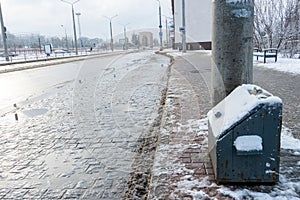 Dirt on the roads due to anti-ice reagents. Safe driving in winter. Use of sand and salt on slippery icy roads and sidewalks. A