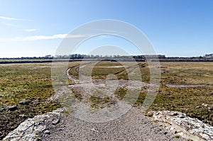 Dirt roads into a great barren grassland