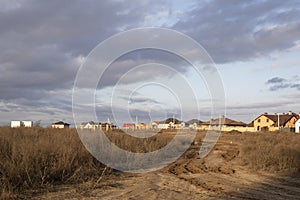 Dirt roadway to new cottage houses. Outland road view