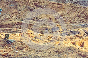 Dirt and sand in random with small stones. Close-up of sand soil background