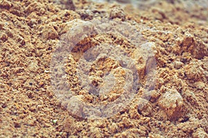 Dirt and sand in random with small stones. Close-up of sand soil background