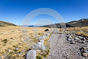 Dirt stone hiking trail to the Laguna Grande de Gredos in Sierra de Gredos mountains, Spain. photo