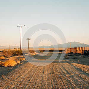 Dirt street with mountains in the distance in Amboy, on Route 66 in the Mojave Desert of California