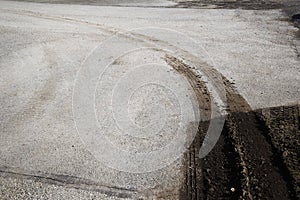 Dirt tire marks on a road going out of the green zone.