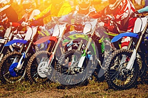 Dirtbike Racers are at start of motorcycles.