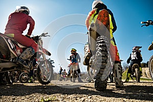 Dirtbike. Team Motocross on bike motorcycle is start road. rear view