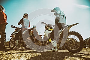 Dirtbike. Team Motocross on bike motorcycle is start road. rear view